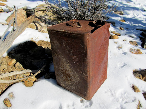 One of many discarded 5-gallon containers, probably once full of white paint