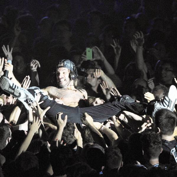 Francois Charon, aka Frah, singer of the Shaka Ponk band, is carried by the crowd during a concert in La Rochelle on July 12, 2014 at the Francofolies festival. 