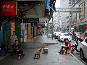 shoeshiners waiting for customers at the same location in Hengyang