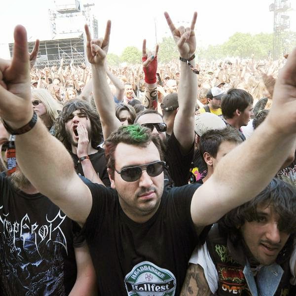 Heavy metal fans gesture during the Hellfest Heavy Music Festival on June 20, 2014 in Clisson, western France.