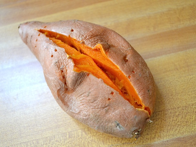 cooked sweet potato with top sliced open 