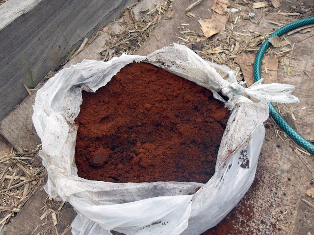 bag of ground coffee in a garden