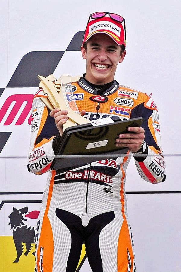 Honda rider Marc Marquez of Spain holds his trophy as he celebrates on the podium after winning the MotoGP race of the Grand Prix of Germany at the Sachsenring Circuit, on July 13, 2014, in Hohenstein-Ernstthal, eastern Germany. 