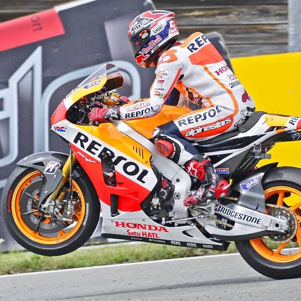 Honda rider Marc Marquez of Spain pulls a wheelie after winning the MotoGP race of the Grand Prix of Germany at the Sachsenring Circuit, on July 13, 2014, in Hohenstein-Ernstthal, eastern Germany. 