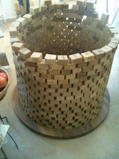 a large circular object made of wood blocks