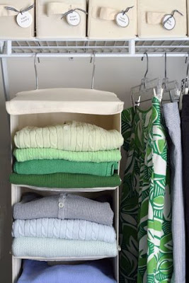 Hanging sweaters in the closet