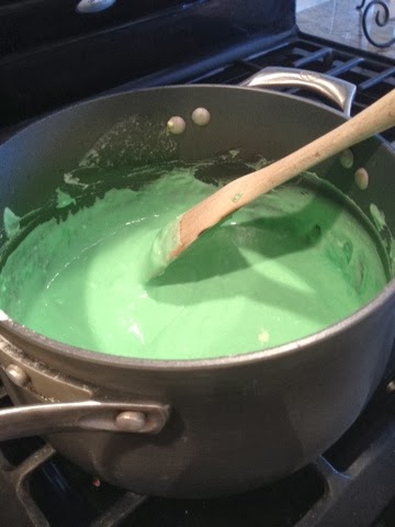 making green homemade play dough on stove