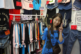 young saleswoman at a clothing shop in Guangzhou, China