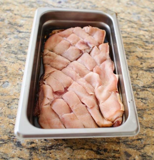 process photo showing raw pork belly with the skin scored