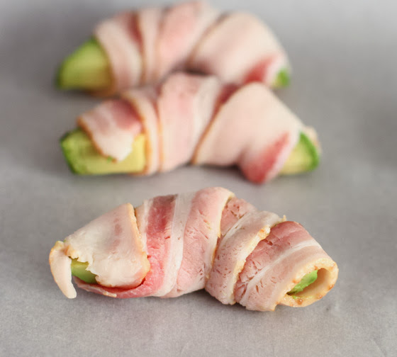 step by step photo showing how to wrap the avocado slices with bacon