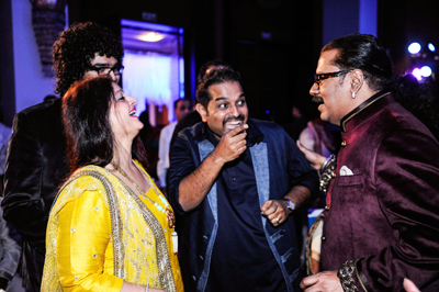 Shankar Mahadevan with his family shares a joke with Hariharan during the sangeet ceremony of the latter's son Akshay, held in Mumbai on January 28, 2013. 