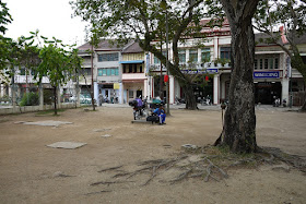 empty dirt area with a few trees in Penang, Malaysia