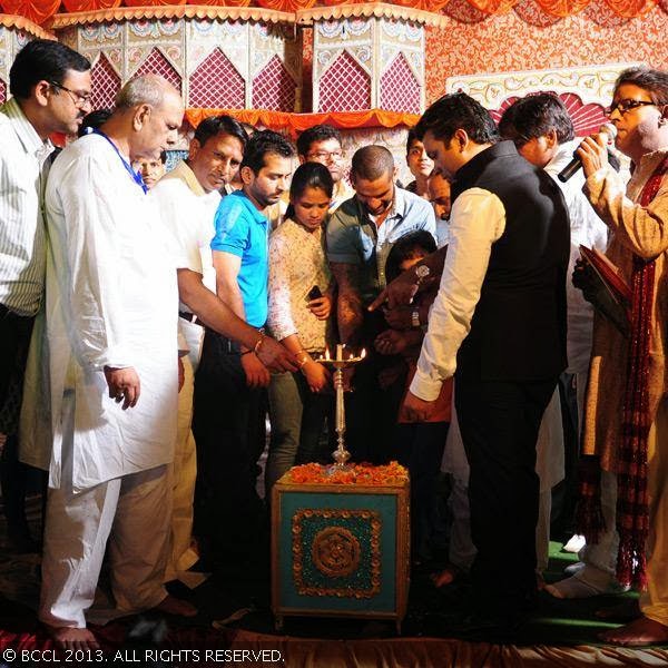Cricketer Shikhar Dhawan lights a lamp at a Ram Leela in north Delhi. 