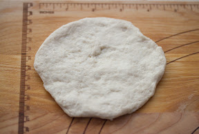 process photo showing how to roll the dough to make the donut