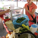 Holly looking on as food vendor cooks up a "soup snack" in Battambang