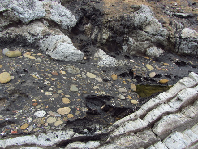 tar from a seep encasing stones