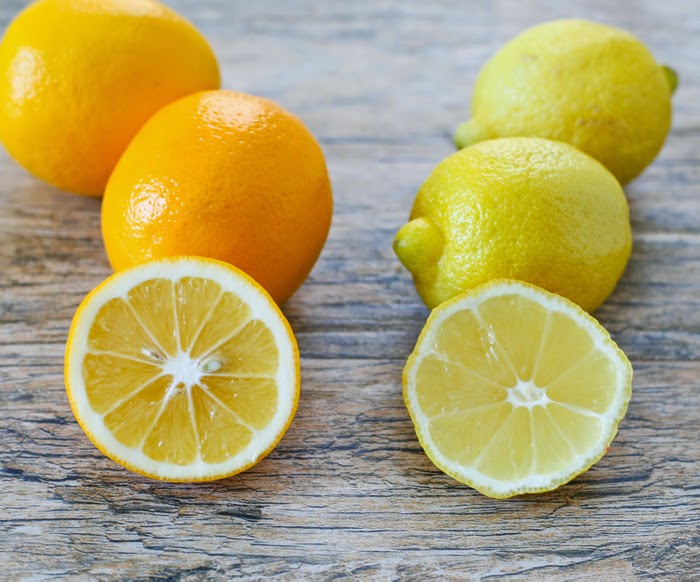 photo the kinds of lemons halved with whole ones in the background