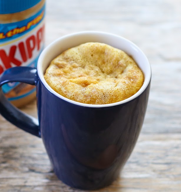 flourless peanut butter mug cake in a blue mug