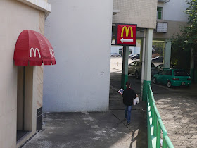 Signs behind a McDonald's in Macau