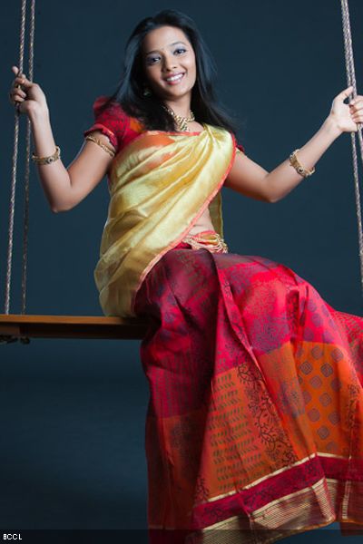 Koshri poses in traditionals during a photoshoot.