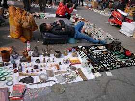 seller sleeping at an outdoor antique market in Changsha, China
