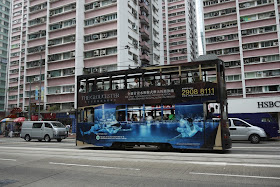 Tram in Hong Kong with The Gloucester condos advertising
