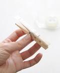 Tape it. Simply place a strip of your permanent double-sided tape onto one side of your clothespin.
