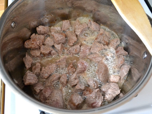 beef stew chunks in pot with moisture from being cooked 