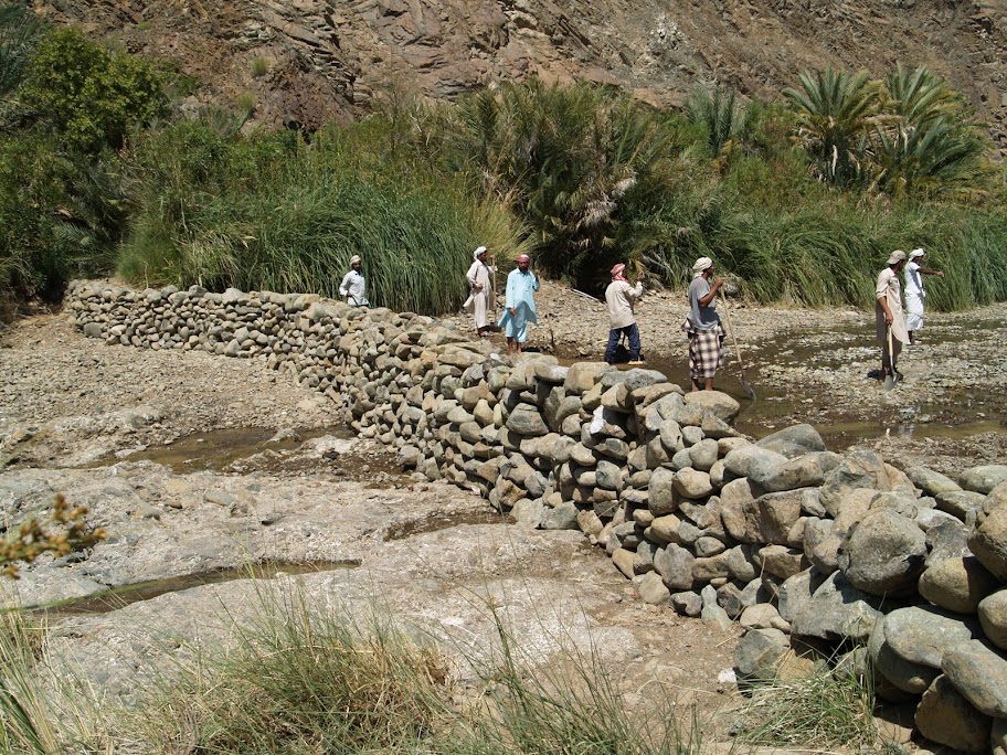 Workers shore up the dam at Wadi Jazira.