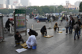 people selling mobile phones on the sidewalk