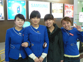 four young ladies at mobile phone store