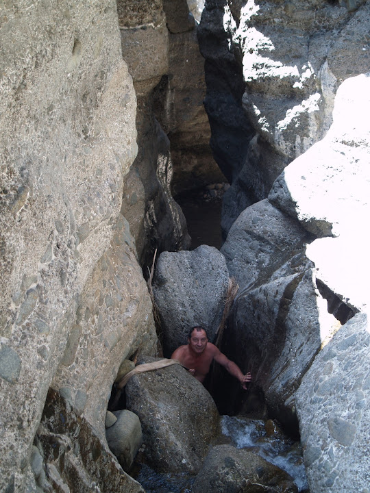 Intrepid explorer Jakobus Britz prepares to descend a waterfall drop with a rope in Wadi Jazira.