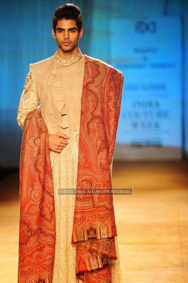 A model walks the ramp for Rimple and Harpreet on Day 6 of India Couture Week, 2014, held at Taj Palace hotel, New Delhi.<br /> 