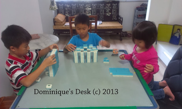 The kids playing with their great grandma's mahjong set