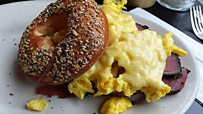 Kenny and Zuke Deli's delicious pastrami brunch with an Everything Bagel and Egg and Cheese (cheddar) with addition of Pastrami