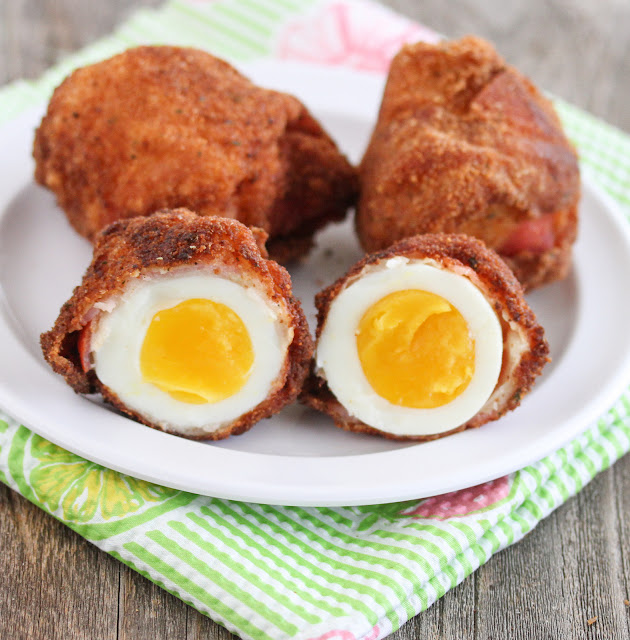 close-up photo of Fried Bacon Wrapped Eggs sliced in half