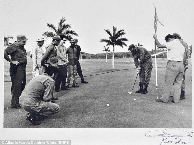 Up for auction: Cuban leader Fidel Castro lines up a putt during his infamous round of golf with Che Guevara in 1961 designed to poke fun at President Dwight Eisenhower who snubbed Castro two years before