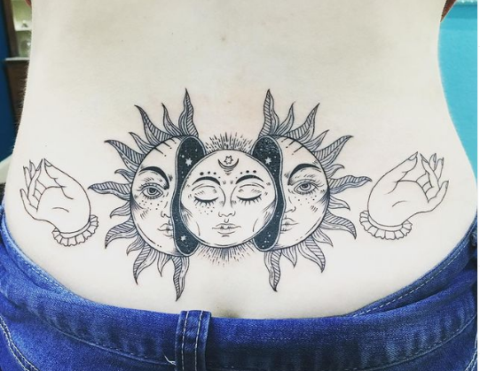 Face Of Sun Lower Back Tattoo