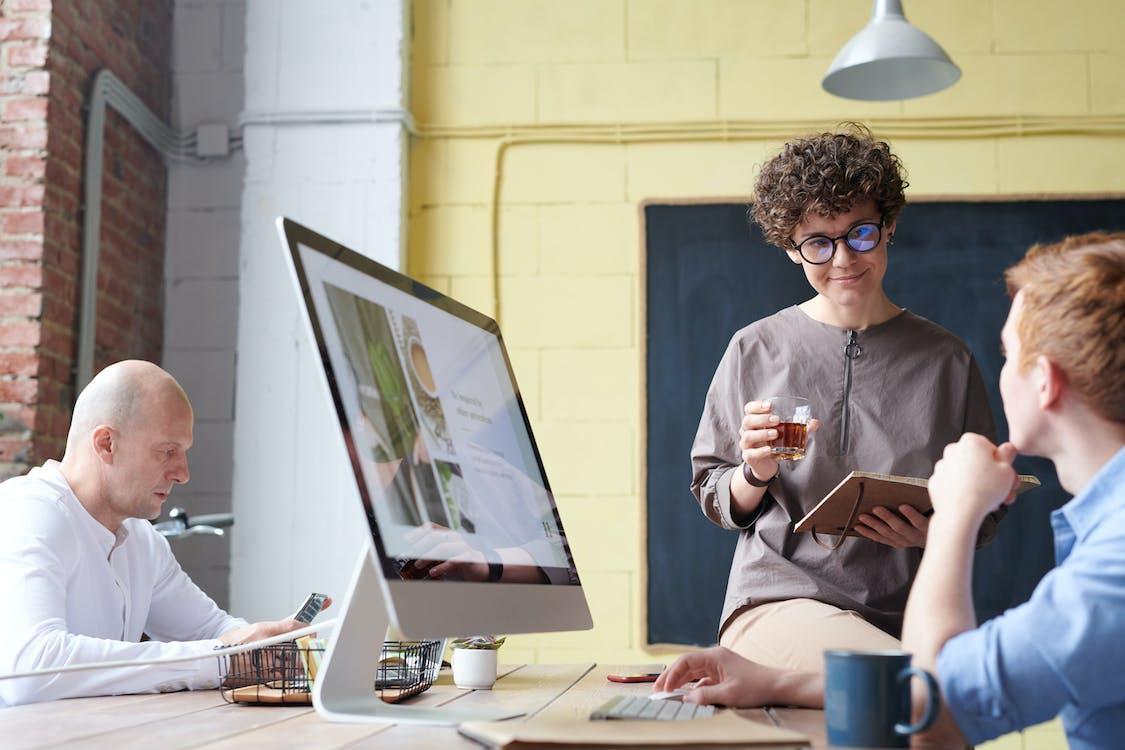 Free Man in Blue Collared Top Using Imac Indoors Stock Photo