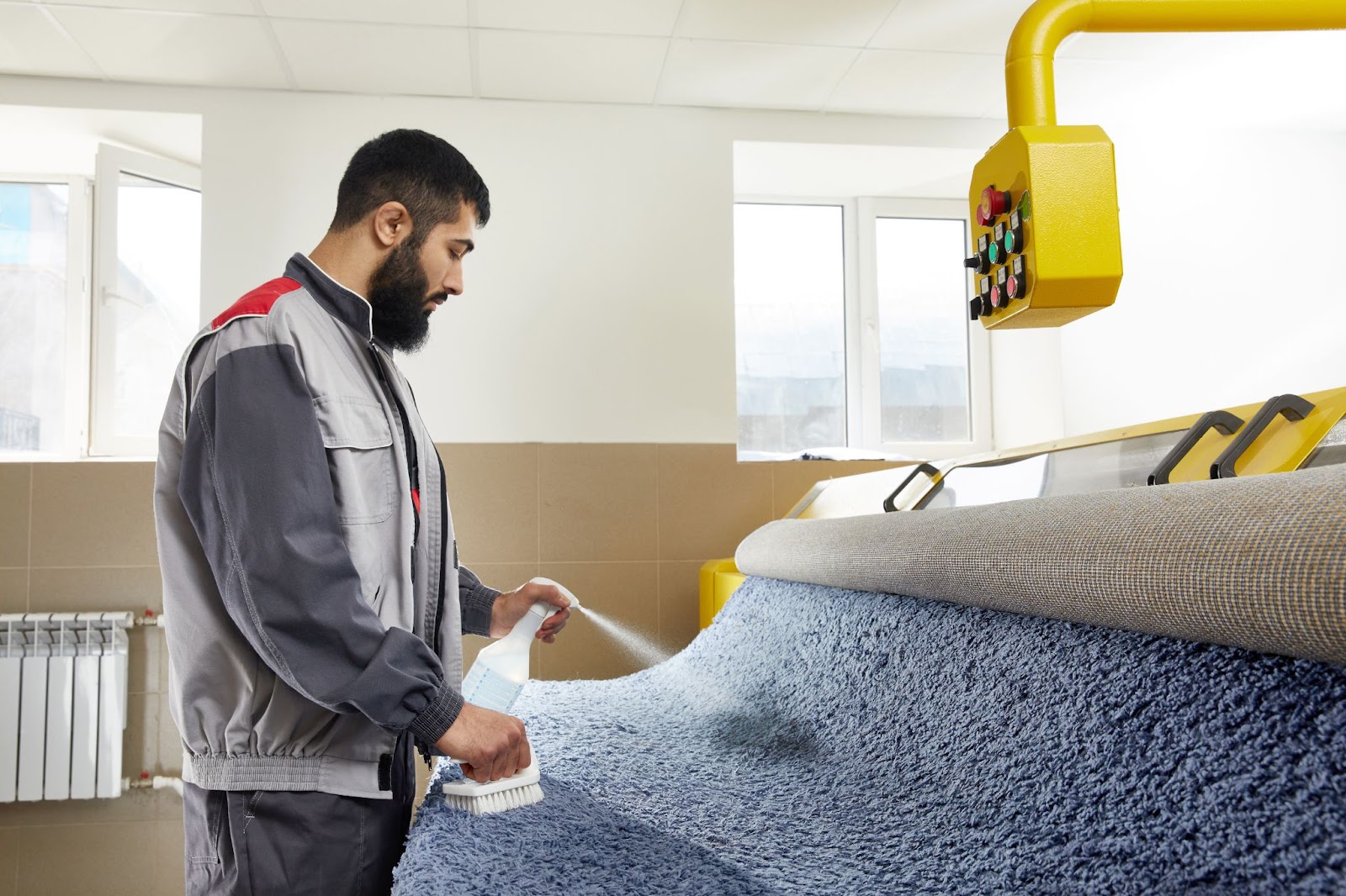 man-cleaning-carpet-using-brush-cleaner