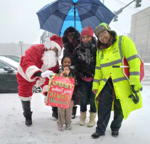 Crossing Gaurd Angela Thompson with children and Santa Claus