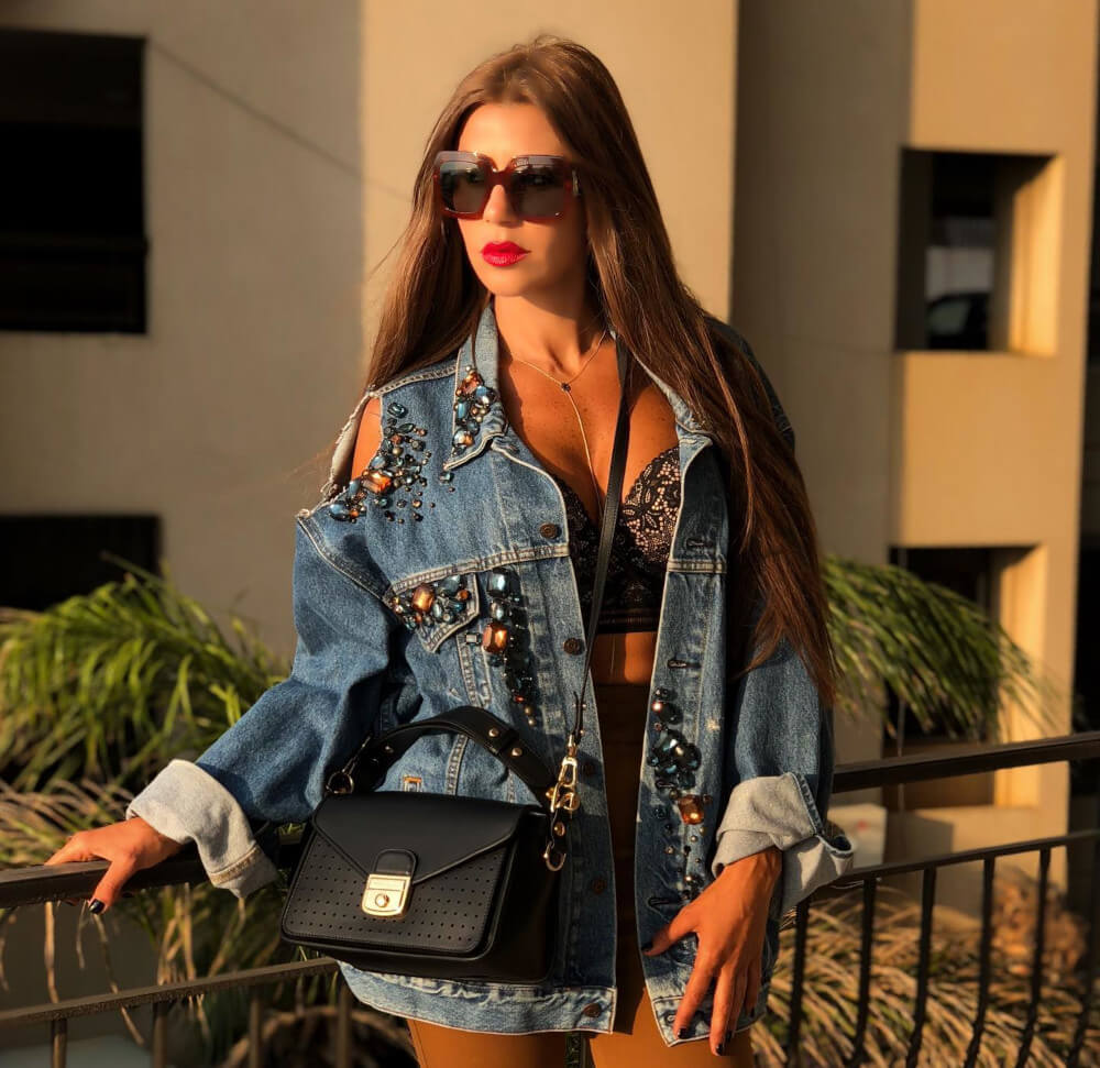 The fashionista comes out  showing off her unique sense of style with this cut out Jean  Jacket, bralettes and shorts and some shades to complete the look 