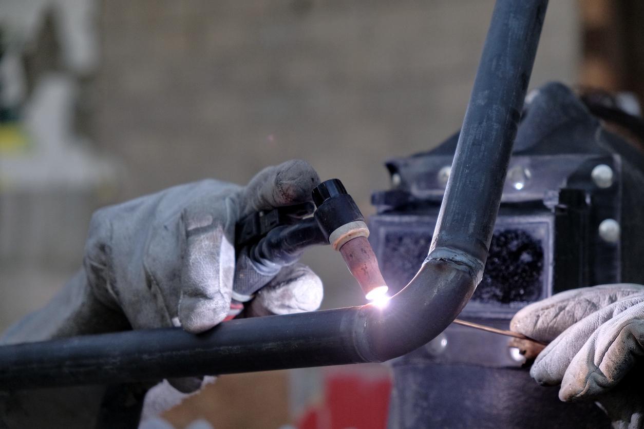 up close hand using welding tool
