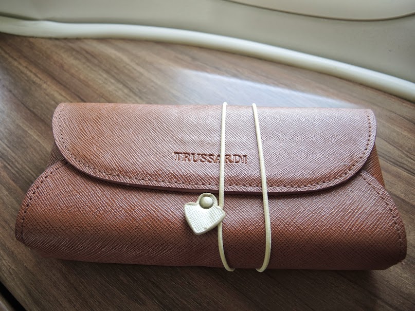 a brown leather case with a white rubber band