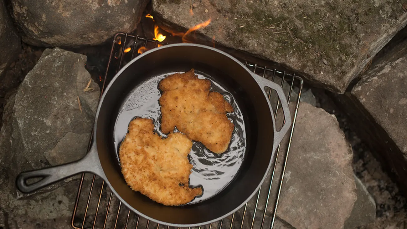 Wild Turkey Schnitzel in cast iron pan over fire