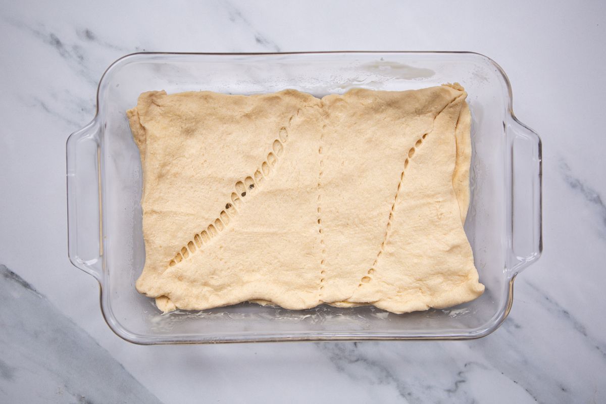 rolled out dough in the casserole dish