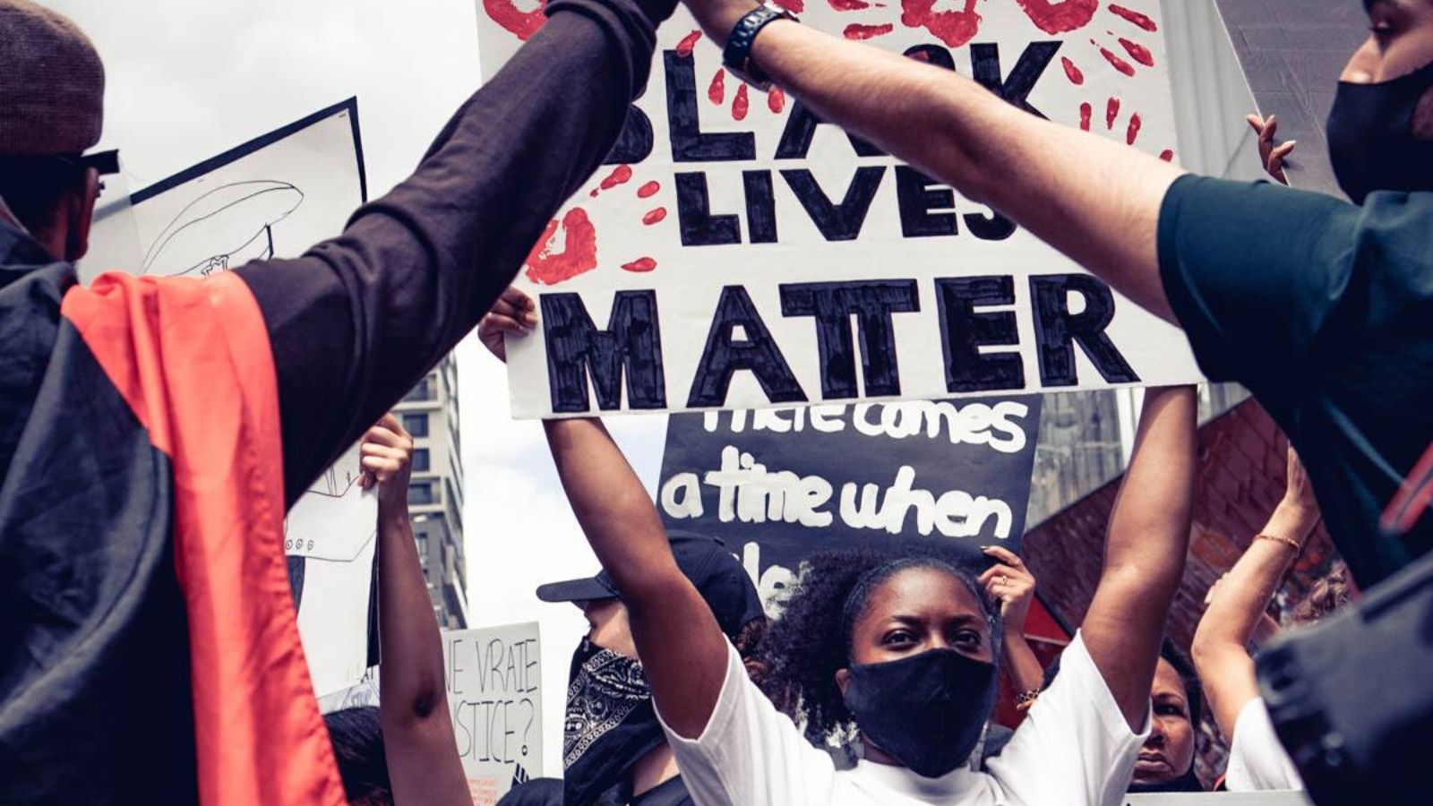 A woman holds a Black Lives Matter sign at a Montreal protest