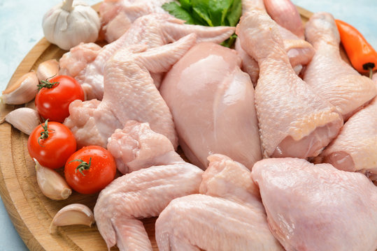 Raw chicken meat on wooden board