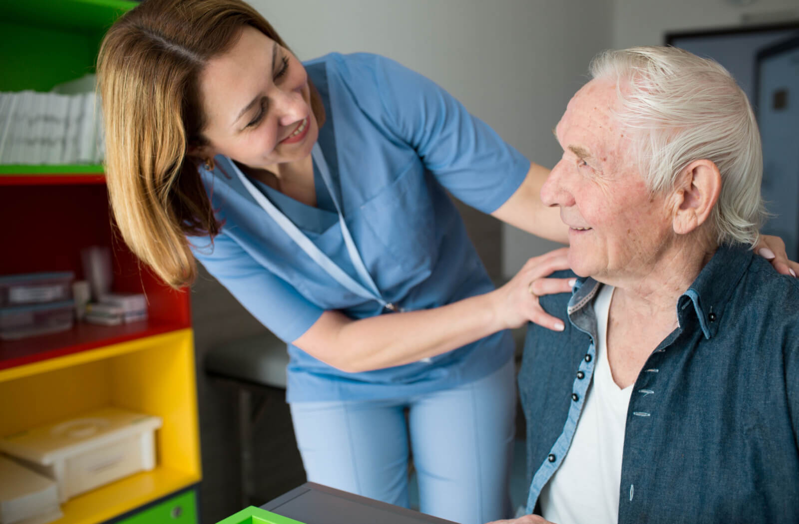 a nurse checks on a person with parkinson's disease in a memory care facility