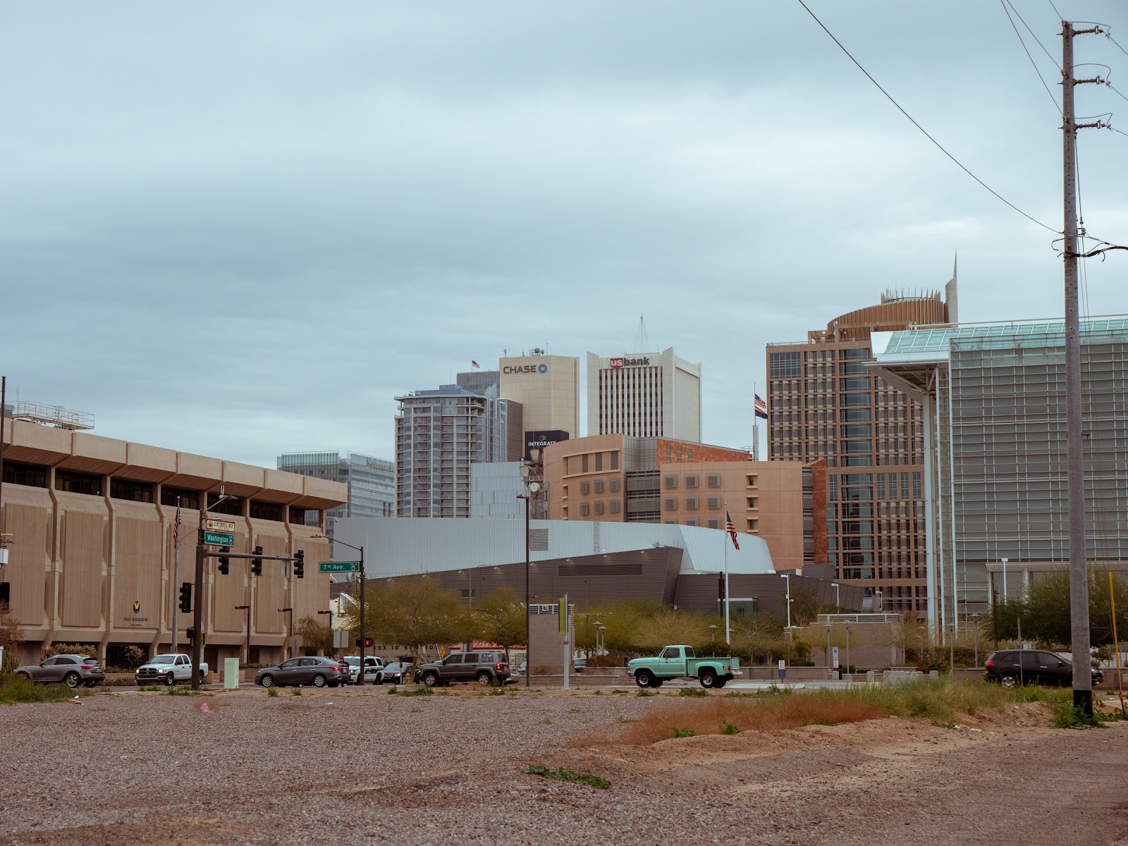 An empty lot with a city skyline in the background.